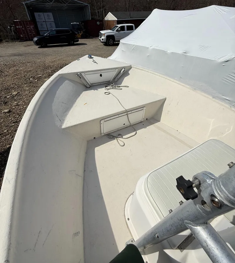 Slide: The Image of 2010 May-Craft 1800 Skiff boat, white interior, parked outdoors. - 9