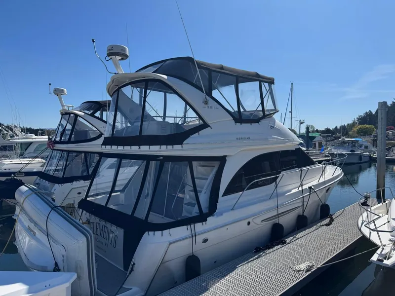 The Image of 2003 Meridian 381 Sedan yacht docked at marina under clear blue sky. - 0