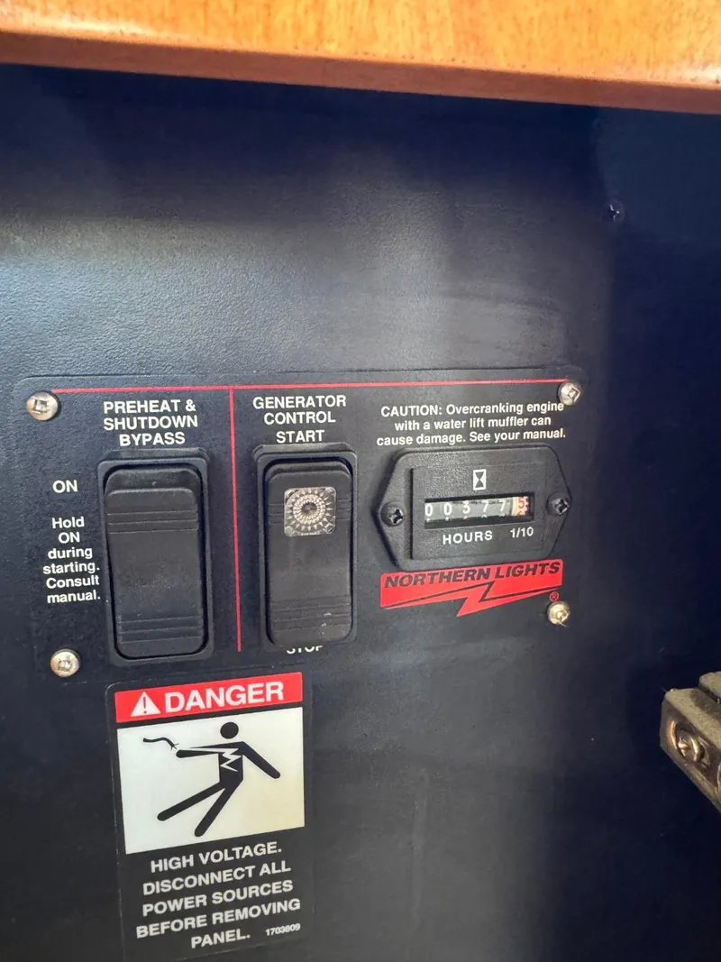 Slide: The Image of Control panel of a 2003 Meridian 381 Sedan with generator controls and safety warnings. - 11