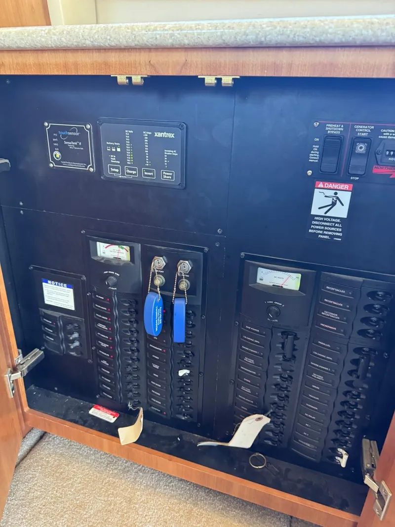 Slide: The Image of Electrical panel inside a 2003 Meridian 381 Sedan boat, featuring switches and meters. - 12