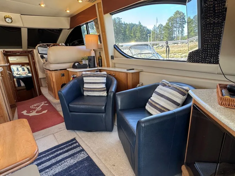 Slide: The Image of Interior of 2003 Meridian 381 Sedan yacht with blue chairs and striped cushions. - 14