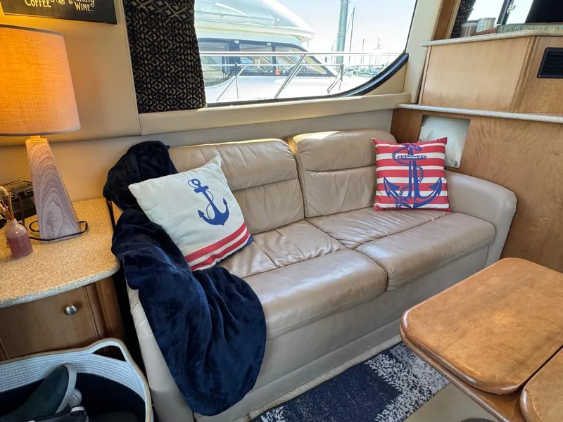 Slide: The Image of Luxurious 2003 Meridian 381 Sedan interior with nautical-themed pillows and cozy seating. - 15