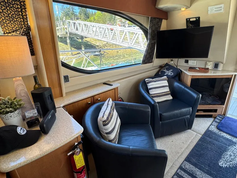 Slide: The Image of Interior of 2003 Meridian 381 Sedan with chairs, TV, and window view. - 18