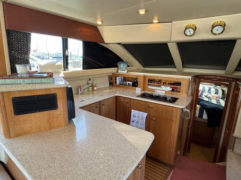 Slide: The Image of 2003 Meridian 381 Sedan yacht interior with modern kitchen and cozy cabin. - 19
