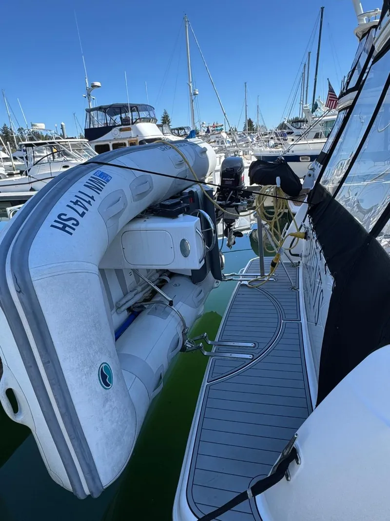 Slide: The Image of 2003 Meridian 381 Sedan yacht with inflatable boat docked at marina. - 2