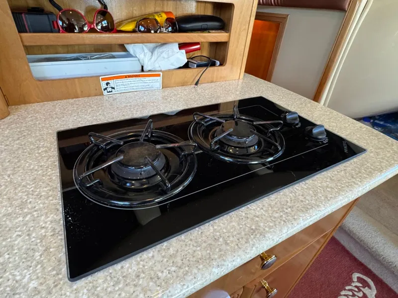 Slide: The Image of Two-burner stove on 2003 Meridian 381 Sedan yacht kitchen countertop. - 25