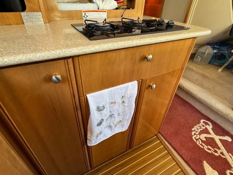 Slide: The Image of Wooden kitchen cabinetry with stove in 2003 Meridian 381 Sedan yacht interior. - 26