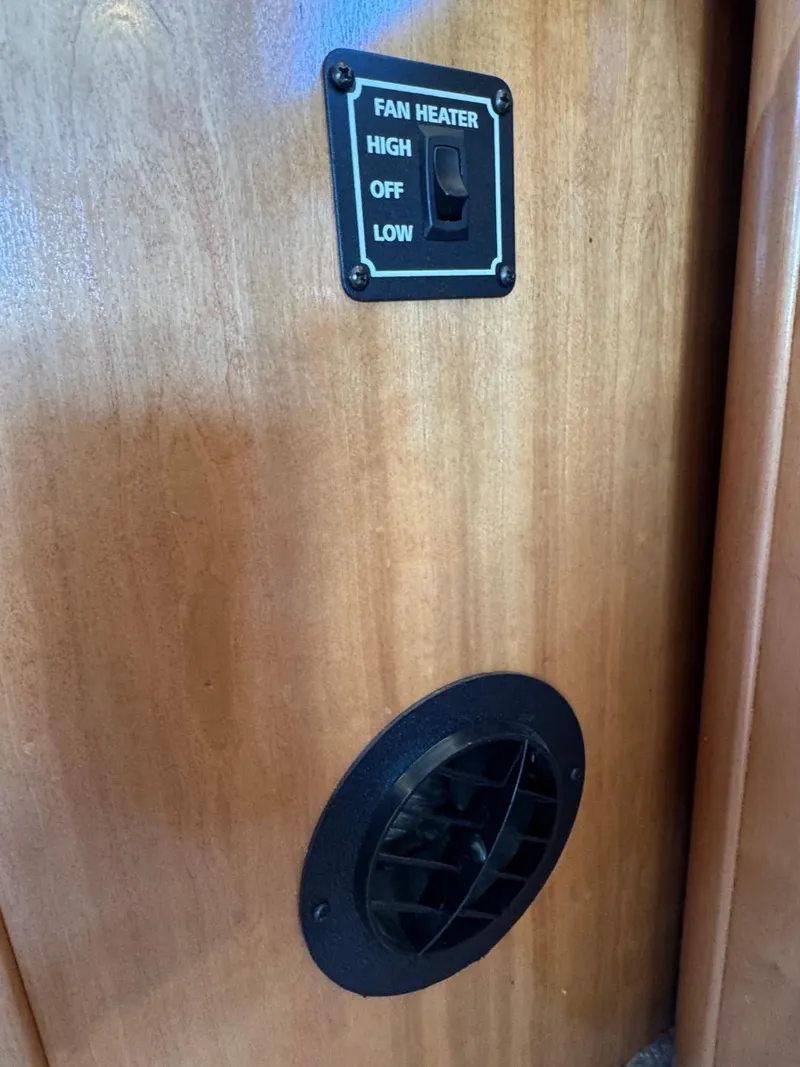 Slide: The Image of Fan heater control panel and vent on 2003 Meridian 381 Sedan boat interior. - 27