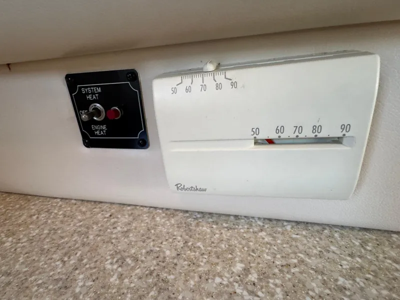 Slide: The Image of Thermostat and heat control panel on 2003 Meridian 381 Sedan boat interior. - 28