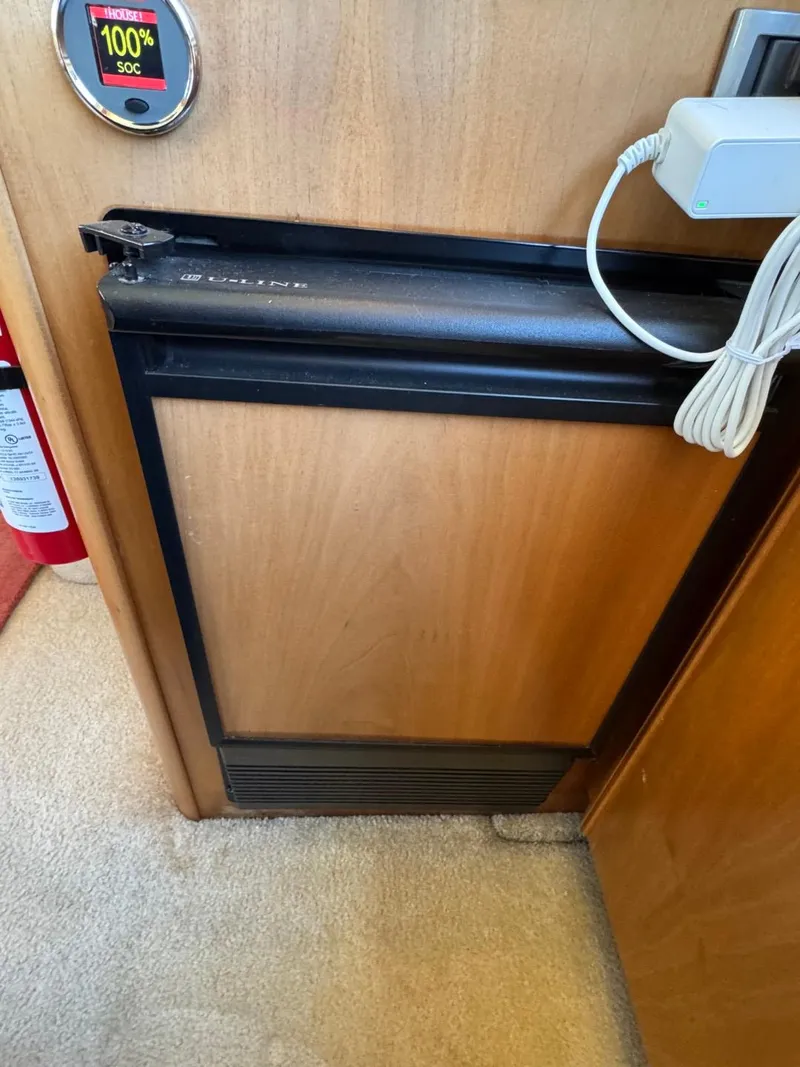 Slide: The Image of 2003 Meridian 381 Sedan interior with compact wooden cabinet and black trim. - 29