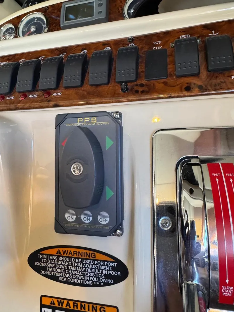 Slide: The Image of Control panel of a 2003 Meridian 381 Sedan boat with warning labels and switches. - 34