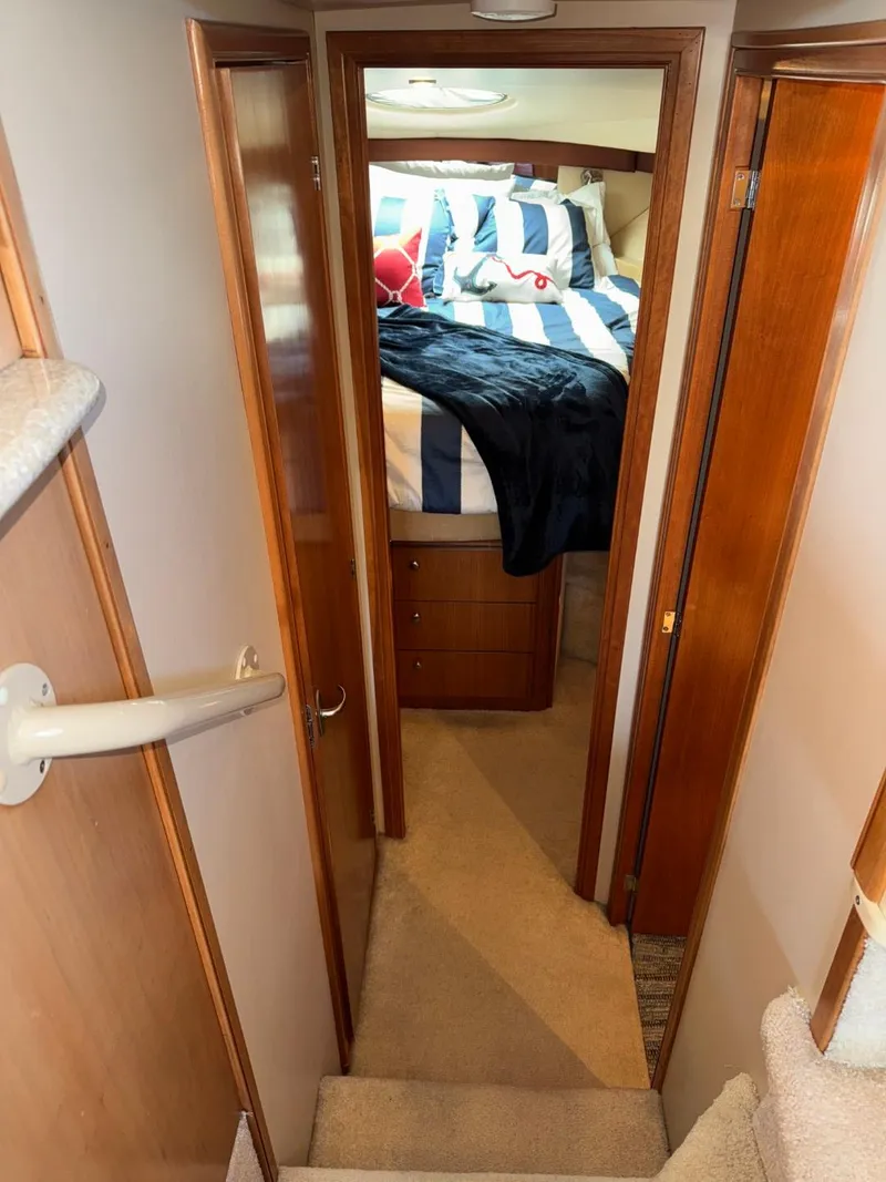 Slide: The Image of Interior of 2003 Meridian 381 Sedan yacht, featuring cozy bedroom with striped bedding. - 37