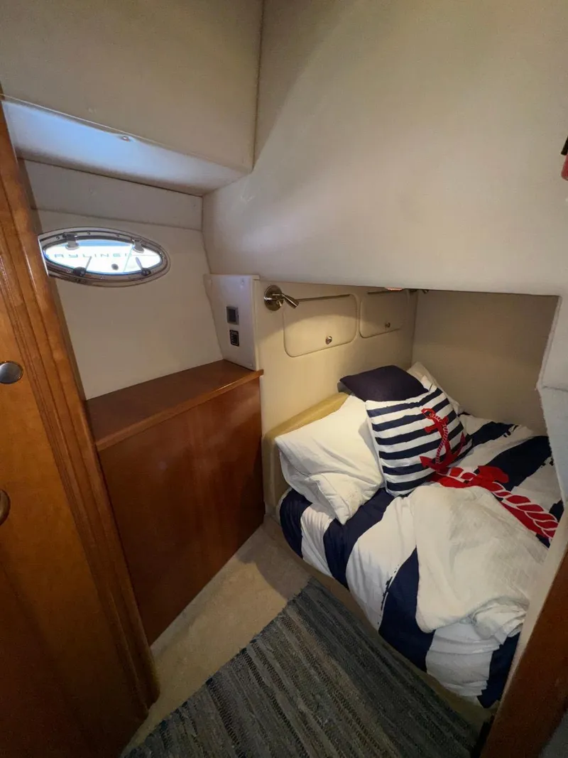 Slide: The Image of Cozy cabin interior of 2003 Meridian 381 Sedan with nautical-themed bedding. - 42