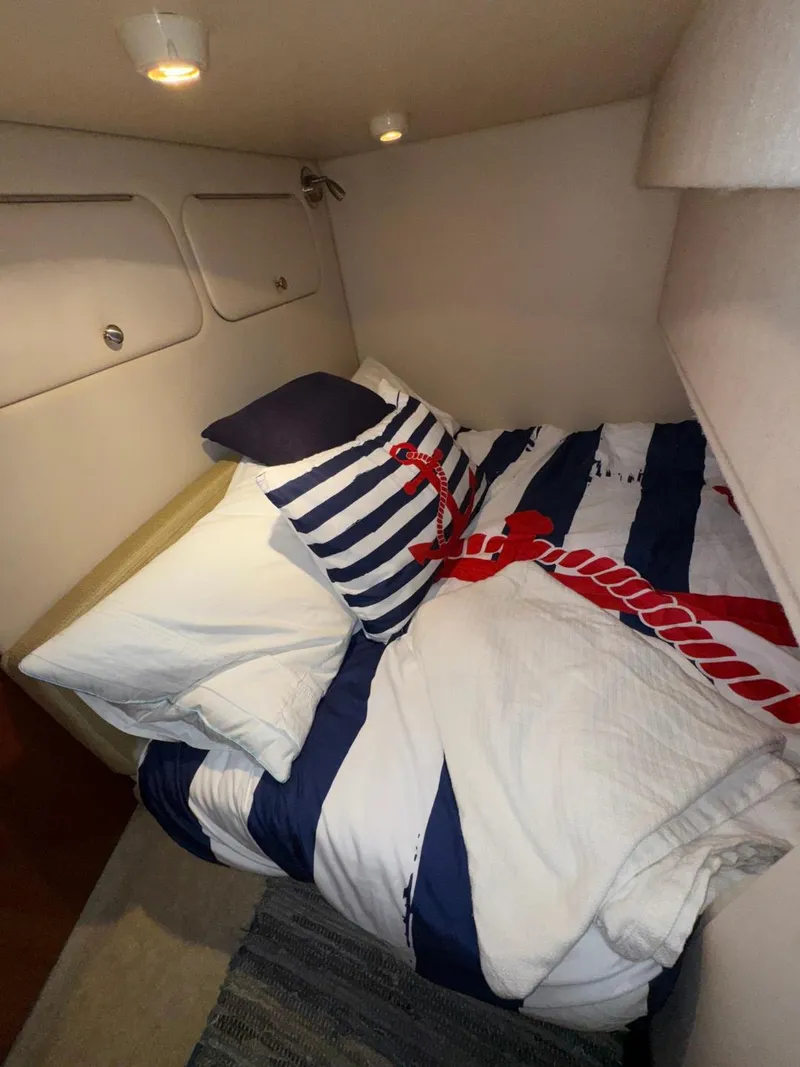 Slide: The Image of Cozy cabin bedroom in 2003 Meridian 381 Sedan with nautical-themed bedding. - 43