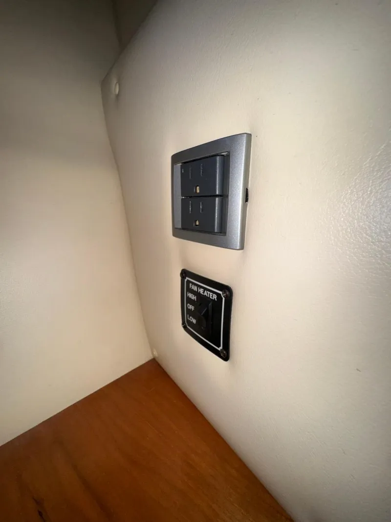 Slide: The Image of Wall-mounted control panel in a 2003 Meridian 381 Sedan boat interior. - 44