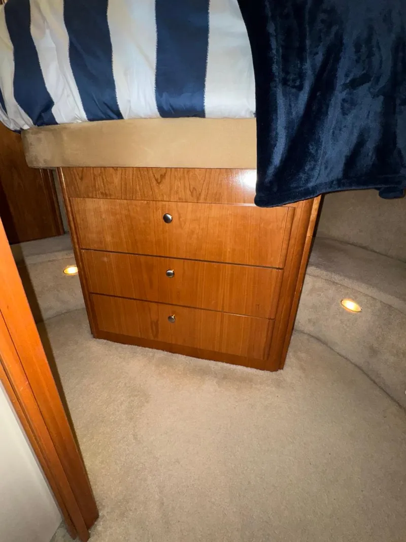 Slide: The Image of Interior of a 2003 Meridian 381 Sedan with wooden drawers and carpeted flooring. - 48