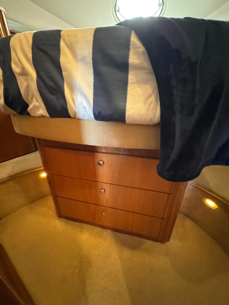 Slide: The Image of Interior of 2003 Meridian 381 Sedan with striped bedding and wooden drawers. - 49