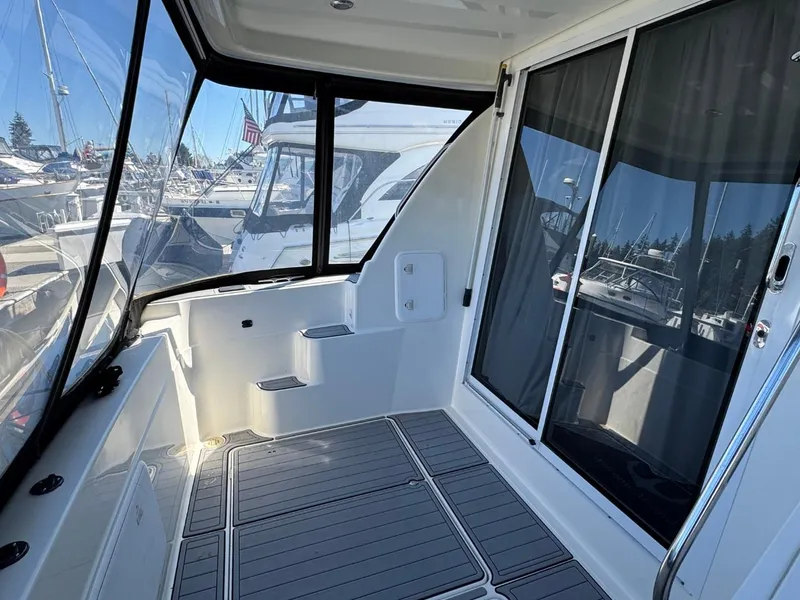 Slide: The Image of 2003 Meridian 381 Sedan yacht interior with sliding glass doors and marina view. - 5
