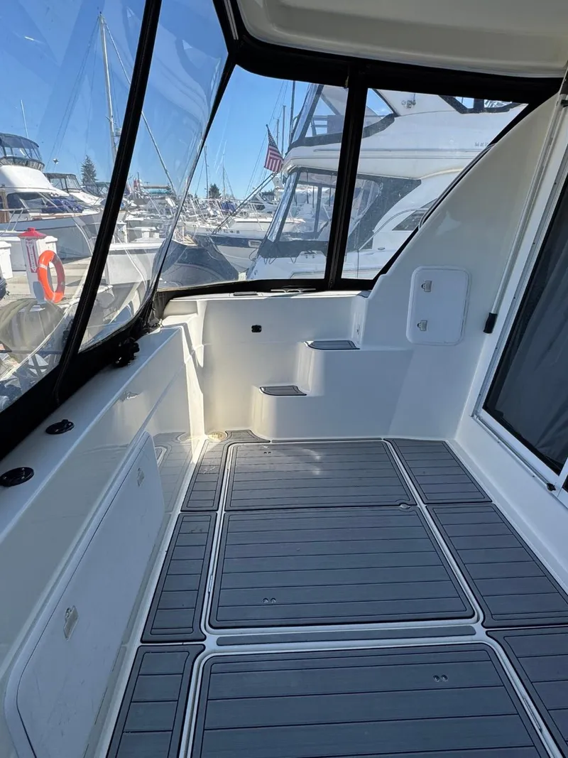 Slide: The Image of 2003 Meridian 381 Sedan yacht deck with modern design and marina view. - 6