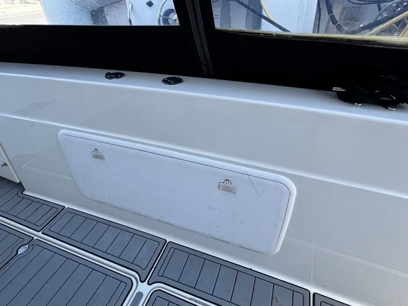 Slide: The Image of 2003 Meridian 381 Sedan boat interior with storage compartment and non-slip flooring. - 8