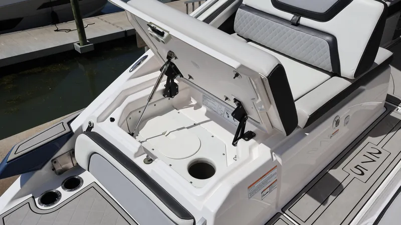 Slide: The Image of 2020 Yamaha Boats 275 SD storage compartment with open hatch, showcasing sleek design and functionality. - 11