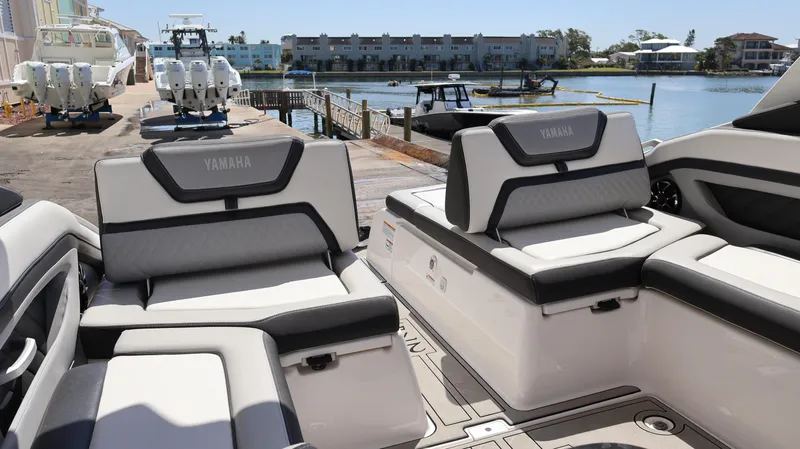 Slide: The Image of 2020 Yamaha Boats 275 SD interior with luxurious seating by the waterfront. - 12