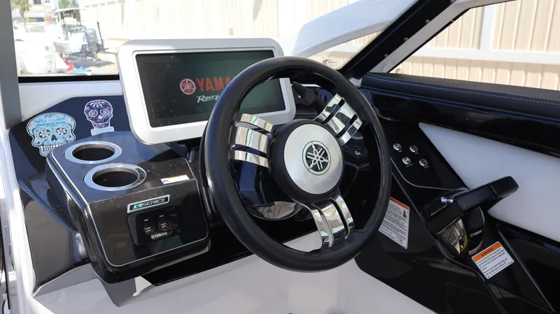 Slide: The Image of 2020 Yamaha Boats 275 SD dashboard with steering wheel and digital display. - 27