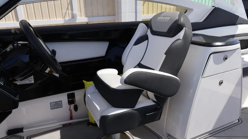 Slide: The Image of 2020 Yamaha Boats 275 SD interior with sleek captain's chair and modern dashboard. - 34