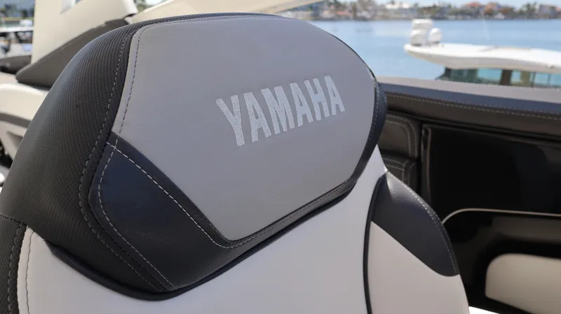 Slide: The Image of Yamaha Boats 275 SD 2020 seat detail with logo, docked by the water. - 35