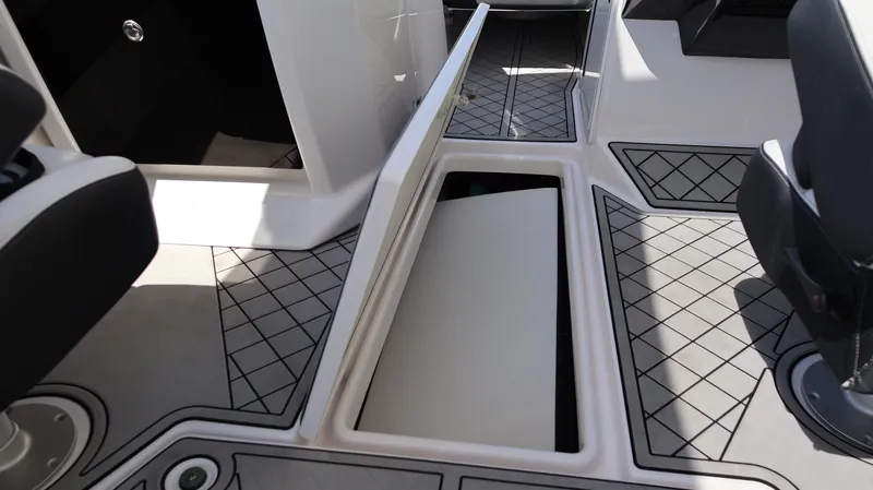 Slide: The Image of 2020 Yamaha Boats 275 SD interior with open storage compartment and stylish flooring. - 38