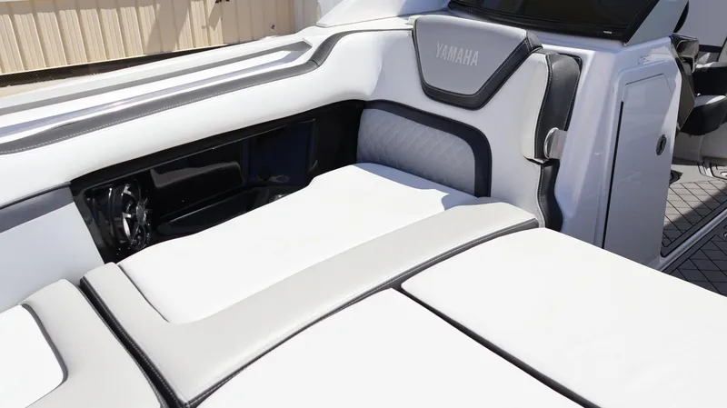 Slide: The Image of 2020 Yamaha Boats 275 SD interior with sleek white seating and modern design. - 40