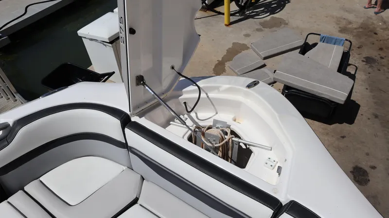 Slide: The Image of 2020 Yamaha Boats 275 SD interior with open storage compartment and seating. - 41