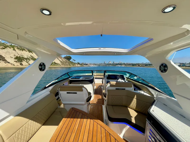 Slide: The Image of Luxurious 2019 Sea Ray SLX 310 boat interior with scenic water view. - 11