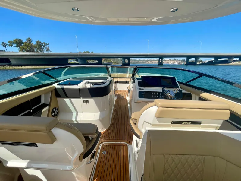 Slide: The Image of 2019 Sea Ray SLX 310 boat interior with luxurious seating and modern dashboard. - 13