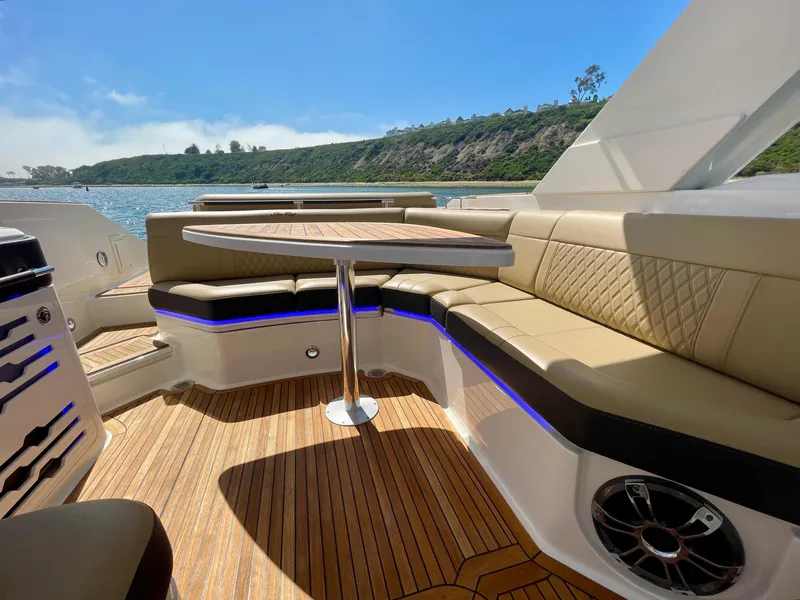 Slide: The Image of Luxurious 2019 Sea Ray SLX 310 boat interior with elegant seating and scenic water view. - 18
