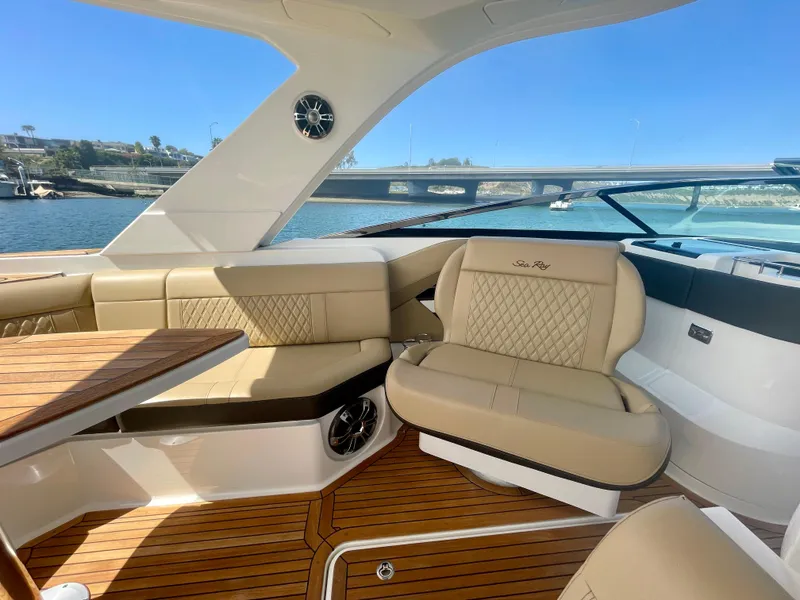 Slide: The Image of Luxurious interior of 2019 Sea Ray SLX 310 boat with beige seating and wooden flooring. - 19