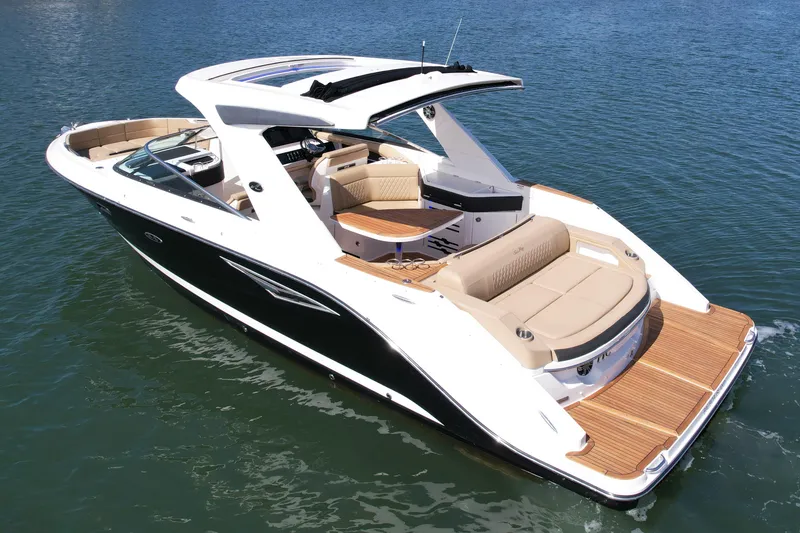 Slide: The Image of 2019 Sea Ray SLX 310 boat on water, featuring sleek design and spacious seating. - 2