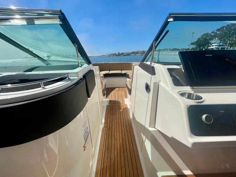 Slide: The Image of 2019 Sea Ray SLX 310 boat interior with sleek design and wooden flooring. - 26