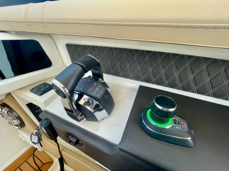 Slide: The Image of 2019 Sea Ray SLX 310 boat controls with joystick and throttle, featuring modern design and technology. - 39
