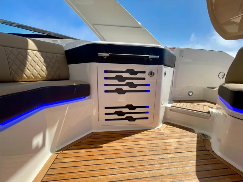Slide: The Image of 2019 Sea Ray SLX 310 interior with wood flooring and modern seating. - 41