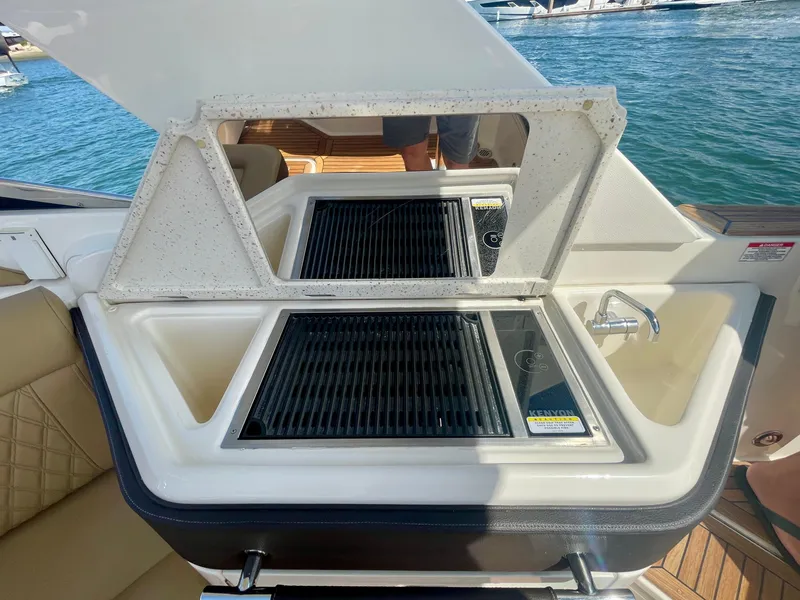 Slide: The Image of Outdoor kitchen on 2019 Sea Ray SLX 310 boat with grill and sink. - 44