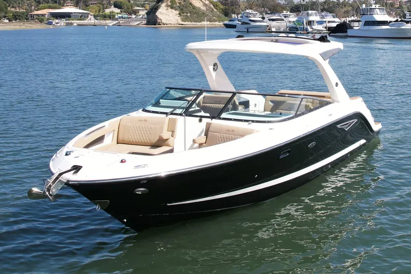 Slide: The Image of 2019 Sea Ray SLX 310 boat on calm water, featuring sleek design and spacious seating. - 5