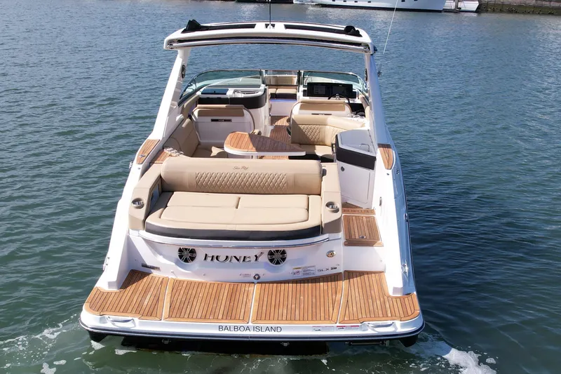 Slide: The Image of 2019 Sea Ray SLX 310 boat with spacious seating, teak flooring, and sleek design on the water. - 6