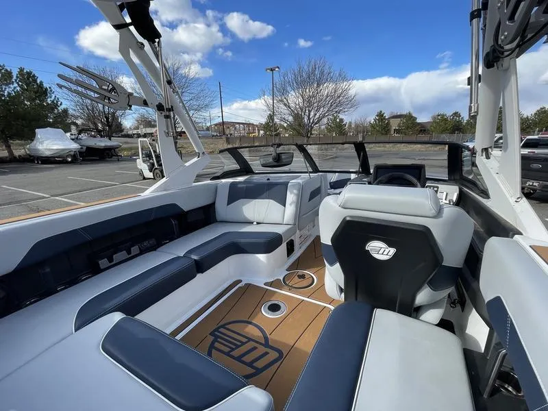 Slide: The Image of 2025 Malibu 20 VTX boat interior with sleek seating and modern dashboard. - 12