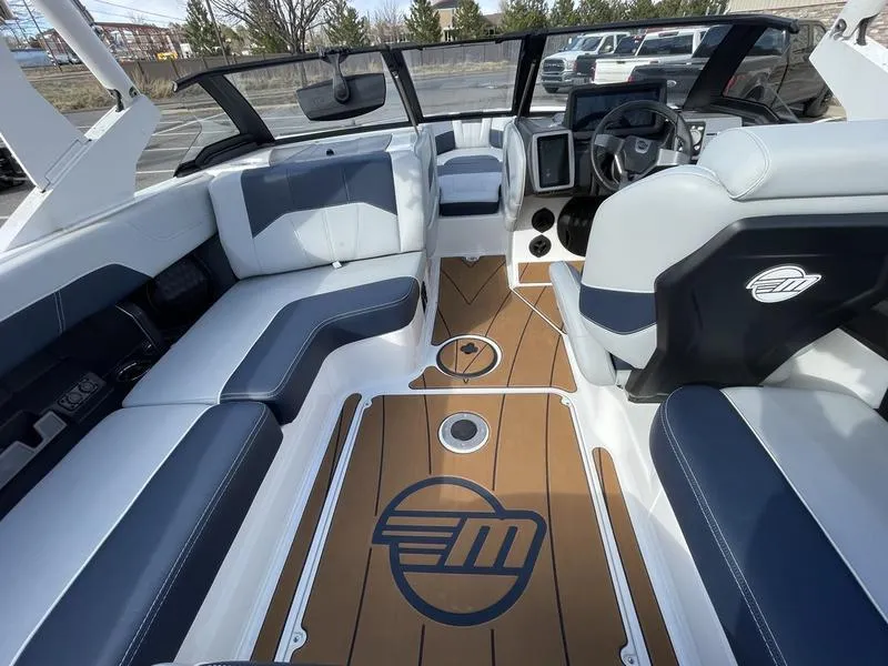 Slide: The Image of 2025 Malibu 20 VTX boat interior with sleek seating and modern dashboard design. - 15