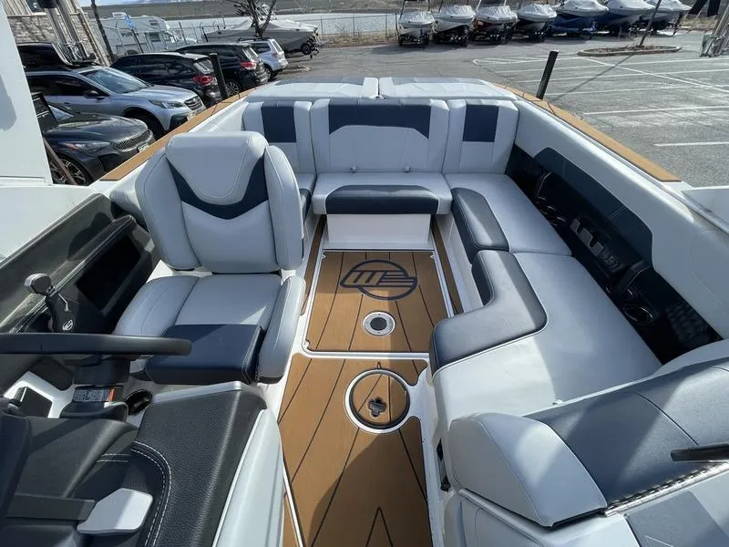 Slide: The Image of 2025 Malibu 20 VTX boat interior with luxurious seating and sleek design. - 18