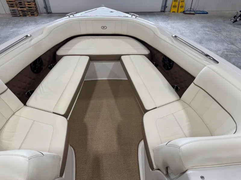 Slide: The Image of 2012 Cobalt 262 BR boat interior with white leather seating and brown accents. - 11