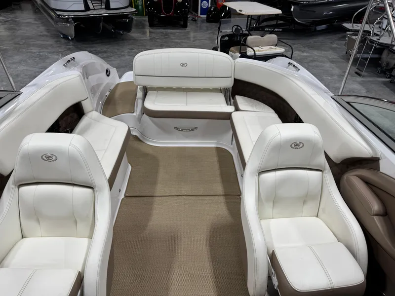 Slide: The Image of 2012 Cobalt 262 BR boat interior with white leather seating and beige carpet. - 15