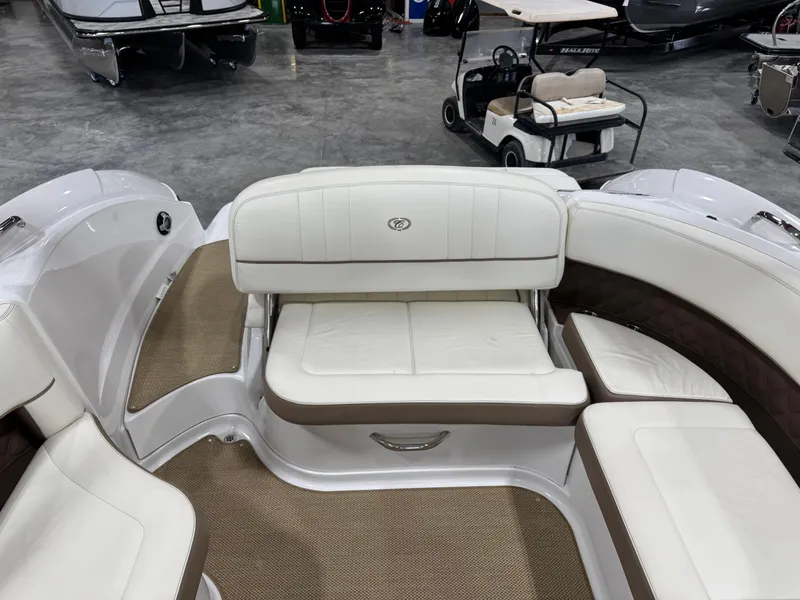 Slide: The Image of 2012 Cobalt 262 BR boat interior with white seating and beige flooring. - 16