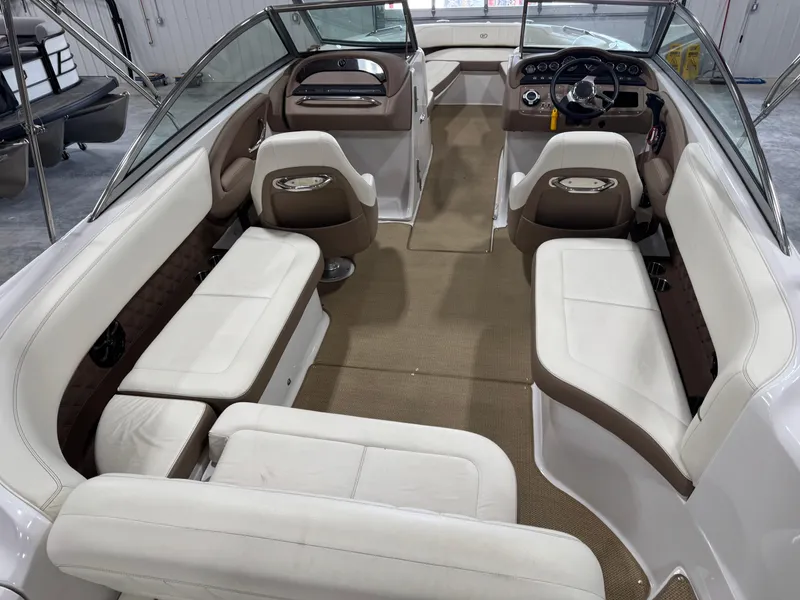 Slide: The Image of Interior of a 2012 Cobalt 262 BR boat with white and brown seating. - 9